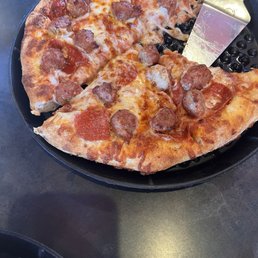 Two small pizzas, one with sausage & pepperoni and the other a Barros special -ham +sausage. Both delicious!