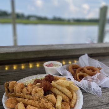 Waterfront Seafood Shack - Two Meat Combinations with a side of onion rings and cucumber and tomato salad. - Seafood Near Me - Calabash, North Carolina Waterfront Seafood Shack - Two Meat Combinations with a side of onion rings and cucumber and tomato salad. - Seafood Near Me - Calabash, North Carolina