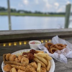 Waterfront Seafood Shack - Two Meat Combinations with a side of onion rings and cucumber and tomato salad.
