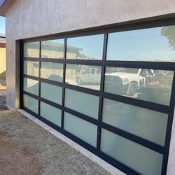 Don's Garage Door Company - This is a black aluminum framed, frosted glass 18x8 full view door installed 9/23 by Don's Garage Door Company.