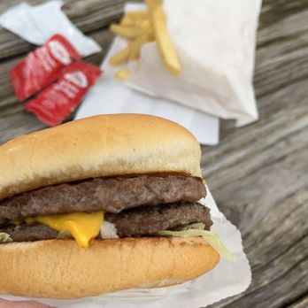 Burger Barn - a hand holding a hamburger and fries - Burgers Near Me - Hawthorne, Florida Burger Barn - a hand holding a hamburger and fries - Burgers Near Me - Hawthorne, Florida