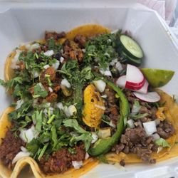 Two al pastor on the left. A steak and pork taco on the right. Very tasty.