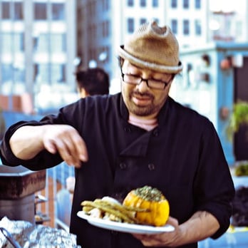 Bean's Pop-Up Cuisine - a man holding a plate of food - New American Near Me Bean's Pop-Up Cuisine - a man holding a plate of food - New American Near Me