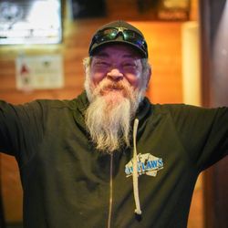 Outlaws Card Parlor - A happy man wearing an Outlaws sweater at Outlaws Card Parlor in Atascadero.