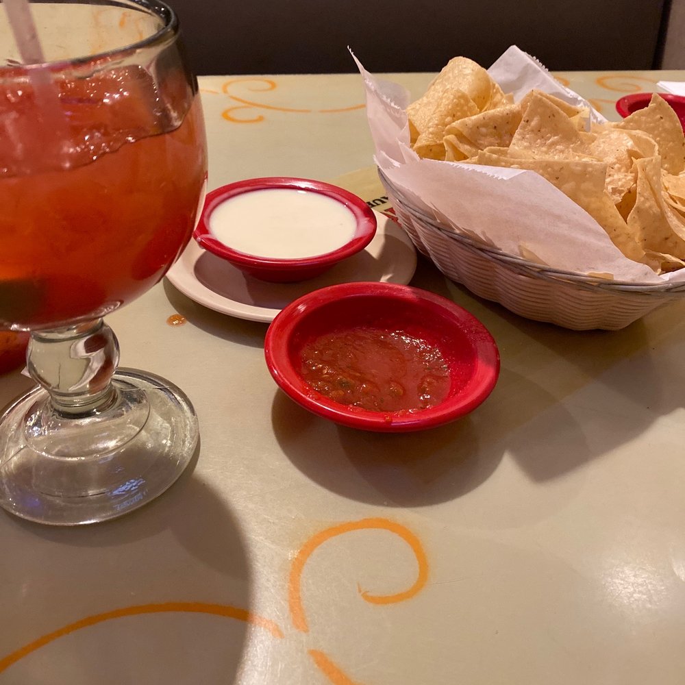 Cheese dip salsa and chips with a margarita Cheese dip salsa and chips with a margarita