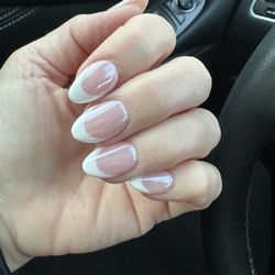 After shot of french manicure acrylic nails with white and chrome finish.