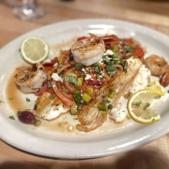 Tavola Trattoria - Sea bass and shrimp over risotto. - Italian Near Me - Bentonville, Arkansas Tavola Trattoria - Sea bass and shrimp over risotto. - Italian Near Me - Bentonville, Arkansas