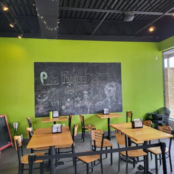 Pita Fusion - tables and chairs in front of a chalkboard - Sandwiches Near Me - Austin, Texas Pita Fusion - tables and chairs in front of a chalkboard - Sandwiches Near Me - Austin, Texas