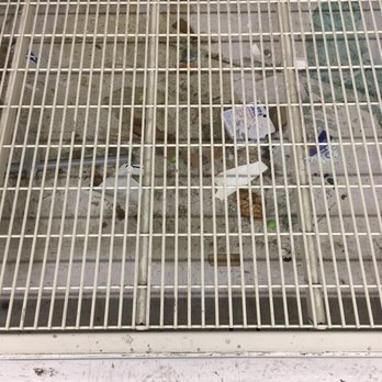 Walmart Supercenter - Filthy build up of garbage and some kind of fluid under racks - Department Stores Near Me - Ellicott City, Maryland