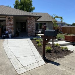 a driveway with a mailbox in the foreground