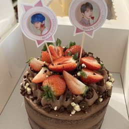 Devil's food cake with chocolate buttercream topped with strawberries and V and Jin Devil's food cake with chocolate buttercream topped with strawberries and V and Jin