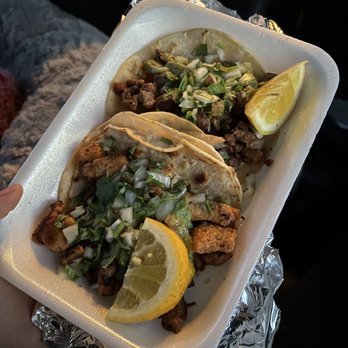 Cotija Taco Shop - a person holding a tray of tacos - Mexican Near Me - Los Banos, California