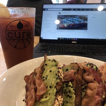 Cure Coffeehouse - Bloody Mary from their brunch menu and avocado toast with bacon. - Coffee & Tea Near Me - Norfolk, Virginia