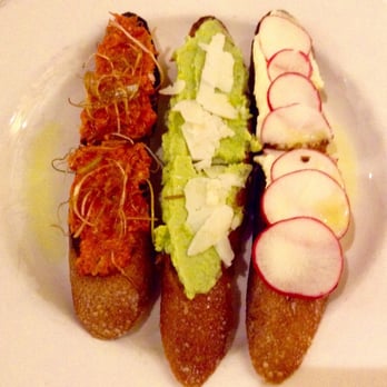 Marche - Tartine trio: hazelnut romesco with crispy leeks, fava bean purée with pecorino, and butter with radishes & sea salt. - French Near Me - Eugene, Oregon