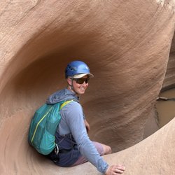Magnum Expeditions - Canyoneer descending into Entrajo Slot Canyon, Moab Utah