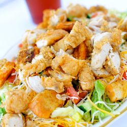 Our House Salad topped with Fried Chicken.