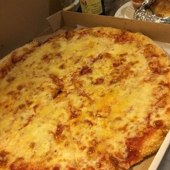 Calabria Pizzeria - The perfect cheese pizza with very generous cheese, crispy thin crust with sesame seeds. - Pizza Near Me - North Bellmore, New York