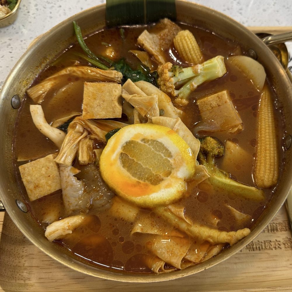Tom yum broth (vegan) with various types of bean curd, veggies, and noodles Tom yum broth (vegan) with various types of bean curd, veggies, and noodles