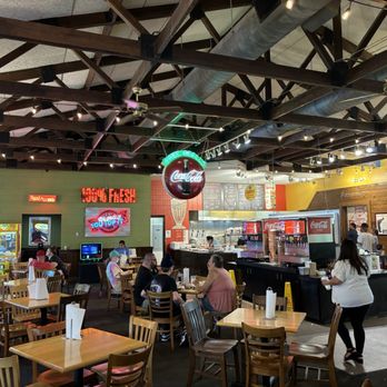 Fuddruckers - Classic open concept restaurant with wood table tops , centrally located fixins bar and drinks , to the right is the famous bakery - Burgers Near Me - Sevierville, Tennessee