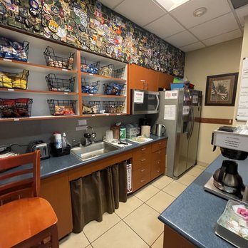 USO - Houston - a kitchen with a refrigerator, sink, and coffee maker - Airport Lounges Near Me - Houston, Texas USO - Houston - a kitchen with a refrigerator, sink, and coffee maker - Airport Lounges Near Me - Houston, Texas