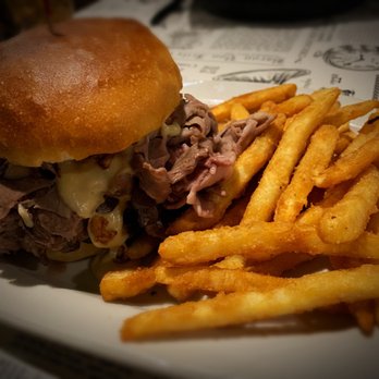 The Grill House - Lumberjack Burger: 8 oz burger topped with shaved prime rib, creamy bleu cheese sauce & crispy onion straws on a gourmet bun. - Steakhouses Near Me - Allegan, Michigan The Grill House - Lumberjack Burger: 8 oz burger topped with shaved prime rib, creamy bleu cheese sauce & crispy onion straws on a gourmet bun. - Steakhouses Near Me - Allegan, Michigan