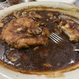 Half eaten Chicken Marsala -side dish of pasta and I think snickers chocolate cheesecake.