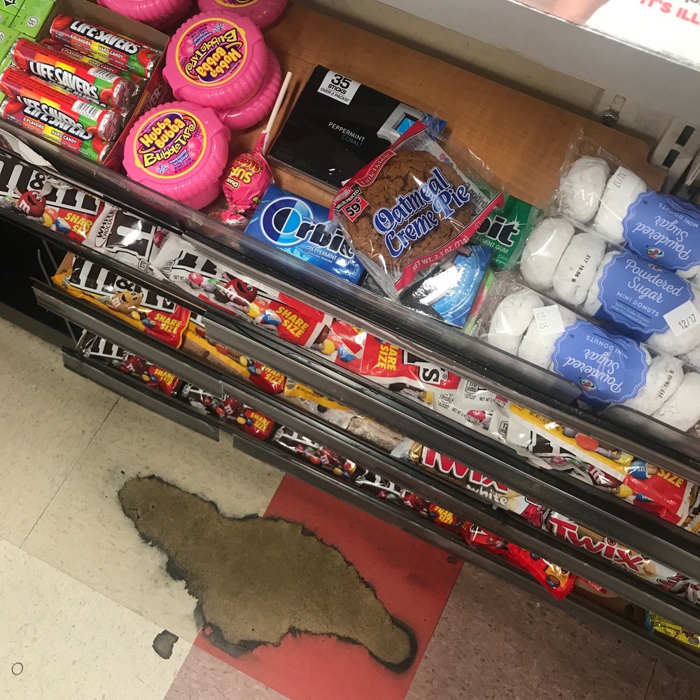 7-Eleven - a person standing in front of a display of candy - Convenience Stores Near Me - Hampton, Virginia