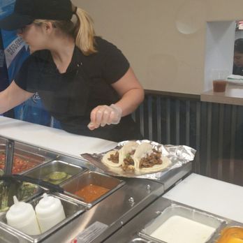 Los Primos Mexican Grill - a woman serving food - Mexican Near Me - Goshen, Indiana