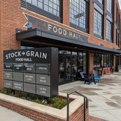 Stock and Grain Assembly Food Hall - Outside. Storefront, patio, and directly. Located next to Truist Point stadium.