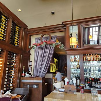 Sage Bistro Moderne - a bar with wine bottles - French Near Me - Woodbury, New York Sage Bistro Moderne - a bar with wine bottles - French Near Me - Woodbury, New York