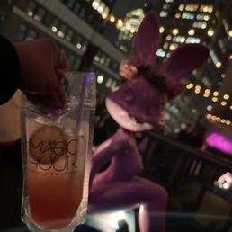 a person holding up a drink a person holding up a drink