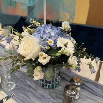 Nancy Sell's Flowers - Baptism centerpiece with bellaflora blue vase - Florists Near Me - Park Ridge, Illinois Nancy Sell's Flowers - Baptism centerpiece with bellaflora blue vase - Florists Near Me - Park Ridge, Illinois
