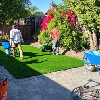 Turf Greens Installation - two men working on a lawn - Artificial Turf Near Me Turf Greens Installation - two men working on a lawn - Artificial Turf Near Me
