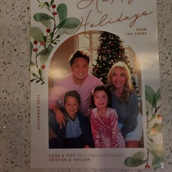 Tiff's Treats - A holiday greeting card with a family photo in front of a Christmas tree, decorated with lights, and festive botanical illustrations. - Bakeries Near Me - Hurst, Texas