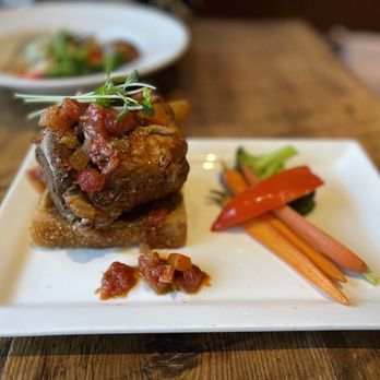 Debb's Cuisine On Queen - Pork Shank Osso Bucco Red wine mirepox jus, Fried Cheese and Herb Polenta and Chef's Seasonal Vegetables - Canadian (New) Near Me - Dunnville, Ontario Debb's Cuisine On Queen - Pork Shank Osso Bucco Red wine mirepox jus, Fried Cheese and Herb Polenta and Chef's Seasonal Vegetables - Canadian (New) Near Me - Dunnville, Ontario