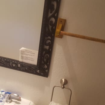 Sandyland Reef Inn - Look at the decor in the bathroom a black frame mirror old wooden towel rack with a stainless steel face cloth rack - Hotels Near Me - Carpinteria, California Sandyland Reef Inn - Look at the decor in the bathroom a black frame mirror old wooden towel rack with a stainless steel face cloth rack - Hotels Near Me - Carpinteria, California