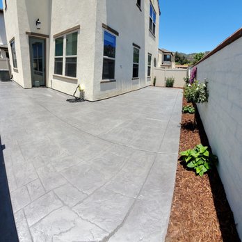 F G Landscape Construction - a concrete patio with a fence - Landscaping Near Me