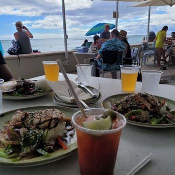 The Beach Bar - Front: Two Catch of the Day with a Bloody Mary and IPAs. Back: Huli Huli Chicken - Bars Near Me - Honolulu, Hawaii The Beach Bar - Front: Two Catch of the Day with a Bloody Mary and IPAs. Back: Huli Huli Chicken - Bars Near Me - Honolulu, Hawaii