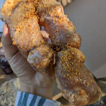 Taylor's Donuts - a hand holding a doughnut - Coffee & Tea Near Me - Lawrence, Kansas Taylor's Donuts - a hand holding a doughnut - Coffee & Tea Near Me - Lawrence, Kansas