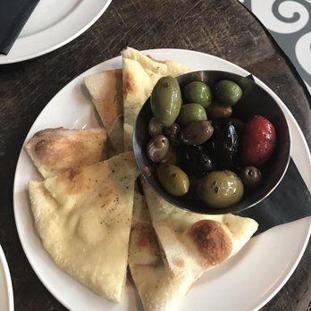 District Bar & Restaurant - Warm olives with housenade flatbread.  Tender and tasty.  $8 at Happy Hour (weekdays 3 to 6 pm). - Cocktail Bars Near Me - Vancouver, British Columbia