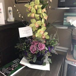 Absolutely beautiful floral arrangement, it is called the Cymbidium Orchid and Rose Elegance on their website.