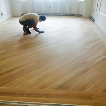 Russo's Flooring - a man cleaning a hardwood floor - Flooring Near Me - Woodmere, New York Russo's Flooring - a man cleaning a hardwood floor - Flooring Near Me - Woodmere, New York