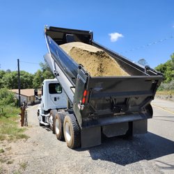 Barcellos Trucking LP - Spreading Base Rock from the top to the bottom