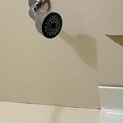 Whispering Pines Cabin - Cracks, torn drywall, and unpainted shower area.