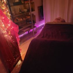 Warm and cozy massage table with soothing sounds and ambience.