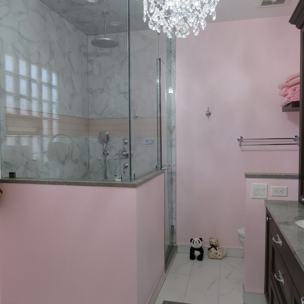 Mahogany Builders - a pink bathroom with a chandelier - General Contractors Near Me - Chicago, Illinois