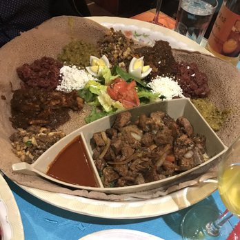 Lalibela Ethiopian Restaurant - Meat combination for two, plus lamb with spicy dipping sauce + honey wine - Ethiopian Near Me - Toronto, Ontario Lalibela Ethiopian Restaurant - Meat combination for two, plus lamb with spicy dipping sauce + honey wine - Ethiopian Near Me - Toronto, Ontario