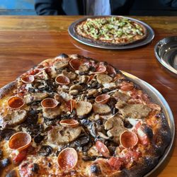 Hopscotch Brick Oven & Taproom - Oven fired pizza at rustic log filled restaurant across the street from Lake Michigan. Good service, they load them toppings.