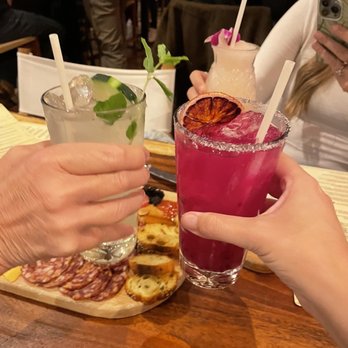 Monarch Ocean Pub - Pink dragonfruit margarita with the Nosh board on the table - Gastropubs Near Me - Del Mar, California