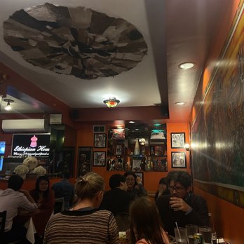Ethiopian House Restaurant - a group of people sitting at a table - Ethiopian Near Me - Toronto, Ontario